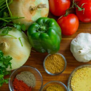 assorted vegetables and spices on wood surface